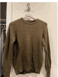 A worn sweater kept separate on a single hanger