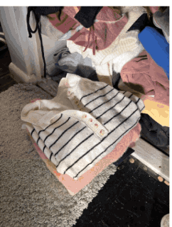 Repeatedly worn clothes folded into a pile on the floor
