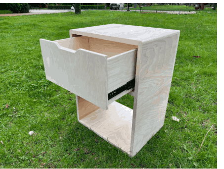 White side table with sliding drawer, photographed outdoors