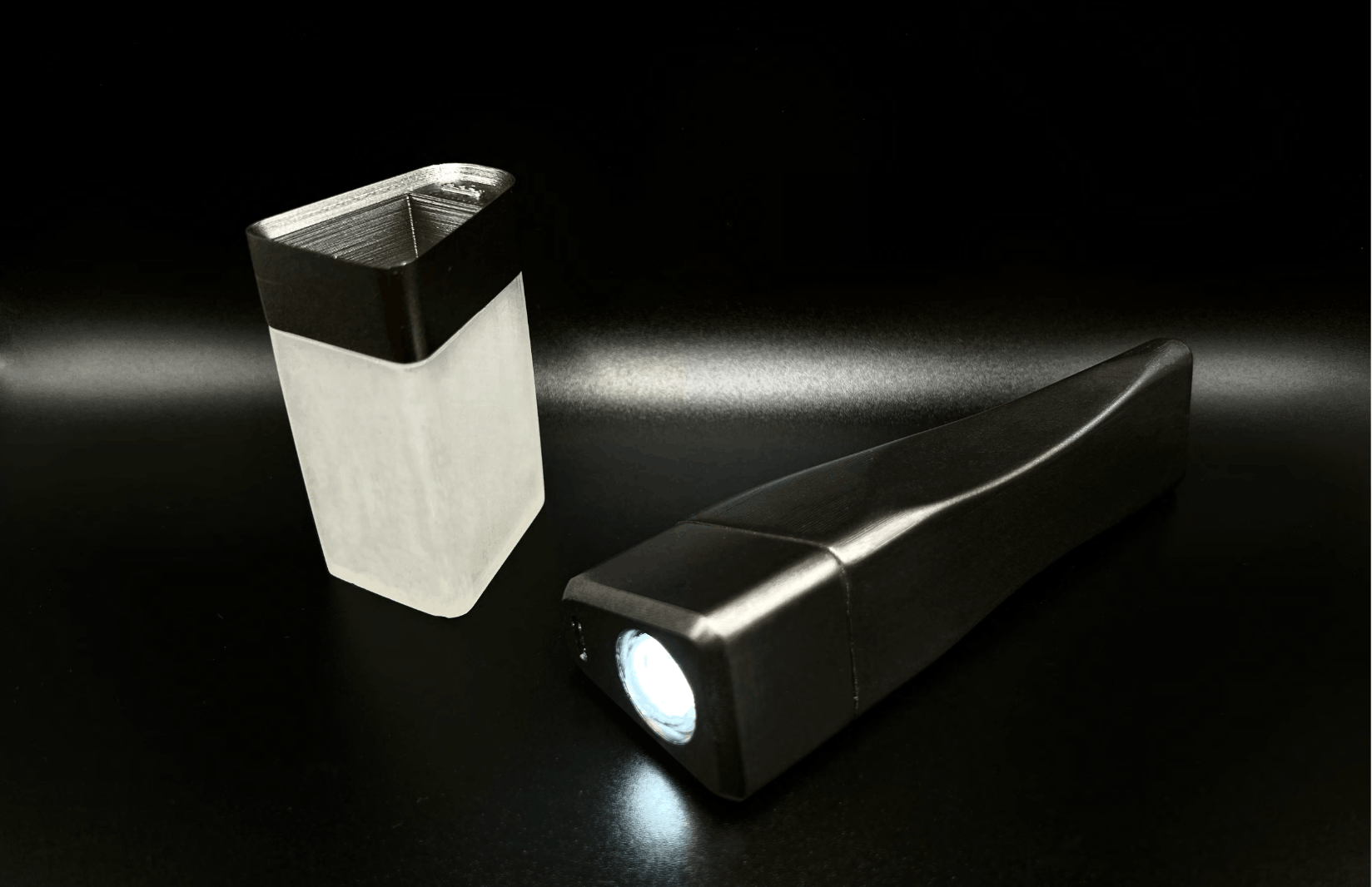 Lumineo flashlight and translucent charging base photographed on a dark surface